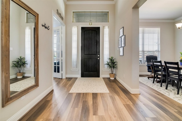 entryway with hardwood / wood-style flooring and ornamental molding