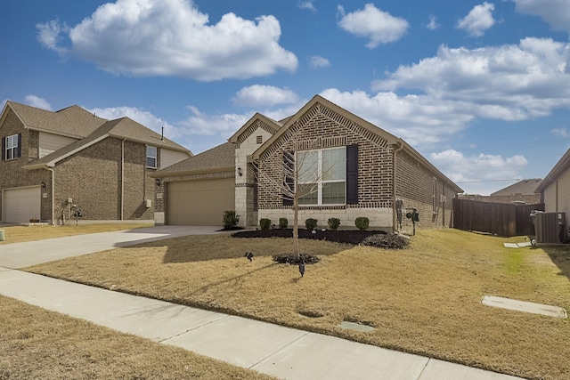 view of front of property with cooling unit, a garage, and a front yard