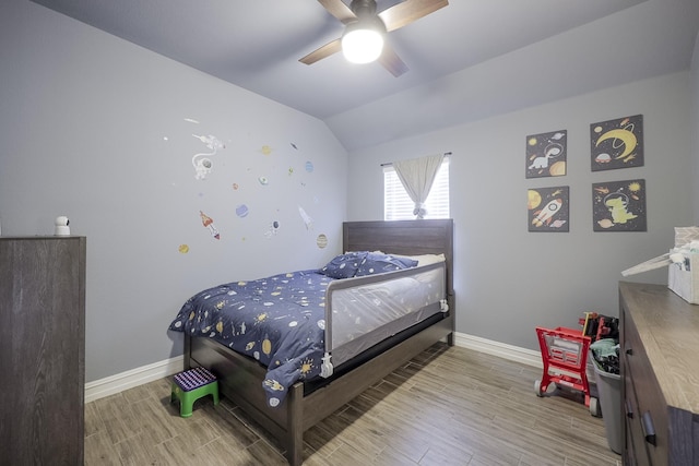 bedroom featuring ceiling fan, lofted ceiling, and light hardwood / wood-style flooring