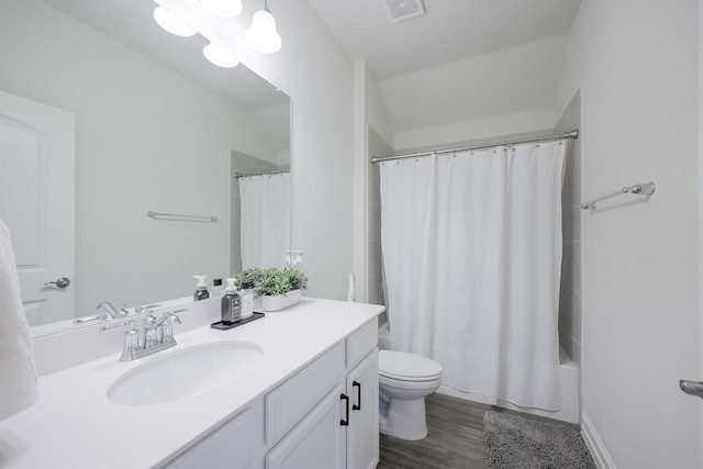 full bathroom with vanity, wood-type flooring, shower / bath combination with curtain, and toilet