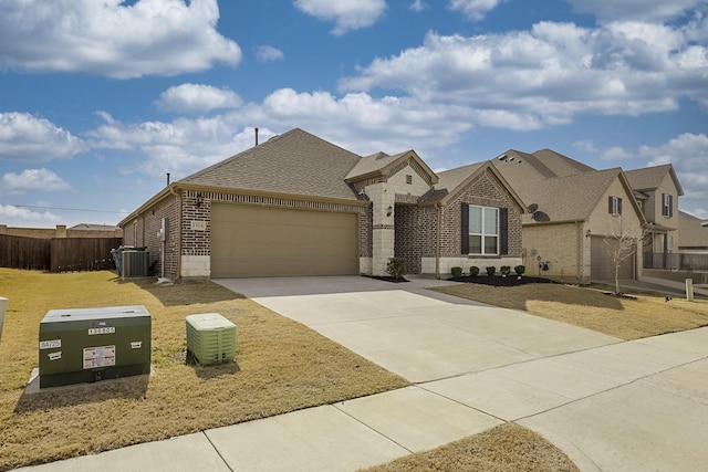 view of front of home with cooling unit and a garage