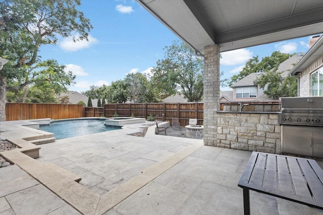 view of swimming pool featuring area for grilling, a fire pit, a patio, and an in ground hot tub