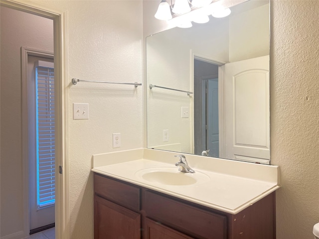 bathroom featuring an inviting chandelier and vanity