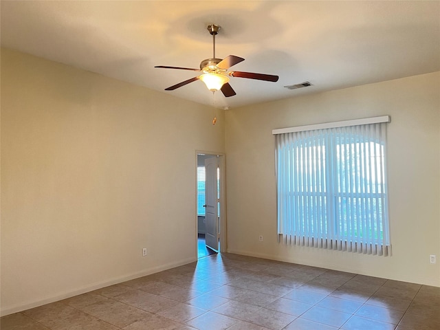 unfurnished room with light tile patterned floors and ceiling fan