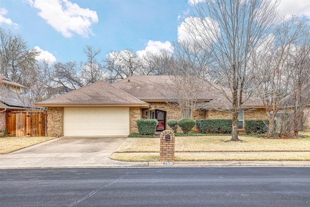 single story home featuring a garage and a front yard