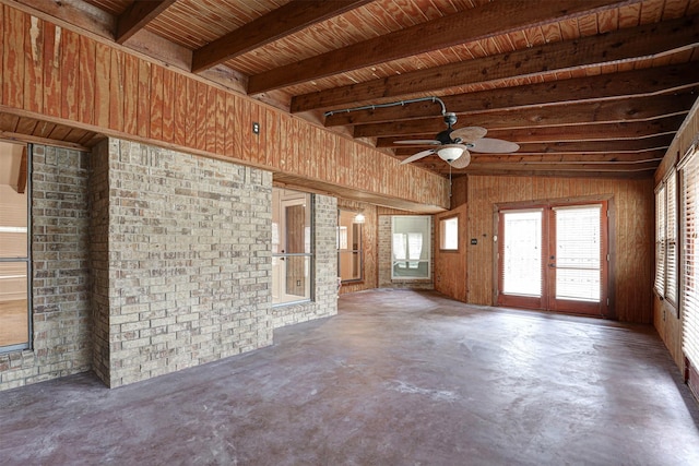 interior space with concrete flooring, ceiling fan, beam ceiling, and french doors