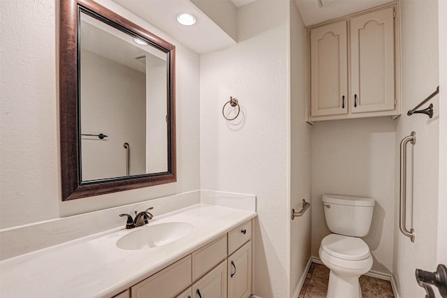 bathroom with vanity, tile patterned flooring, and toilet