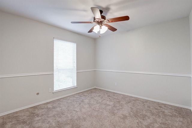 empty room with ceiling fan, plenty of natural light, and light carpet