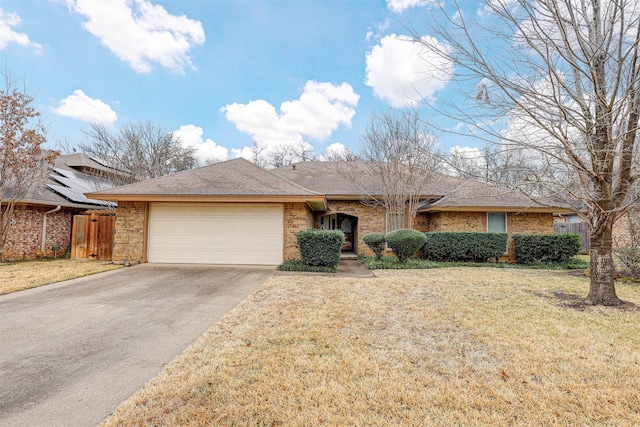 ranch-style home with a garage and a front yard