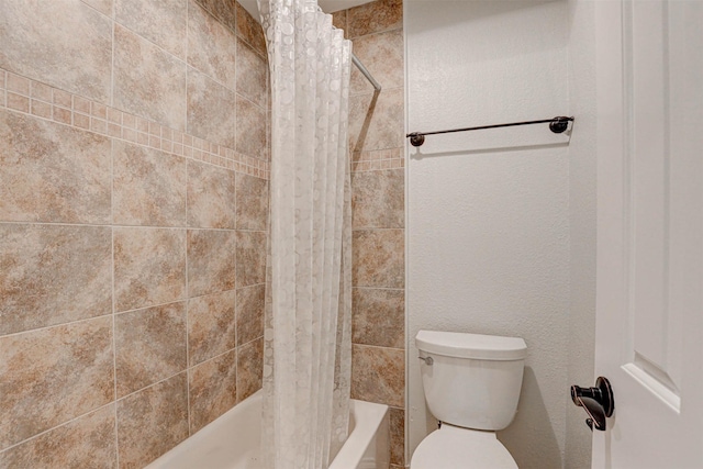 bathroom with toilet and shower / tub combo