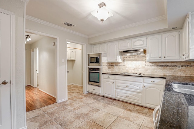 kitchen featuring stainless steel appliances, white cabinetry, crown molding, and decorative backsplash