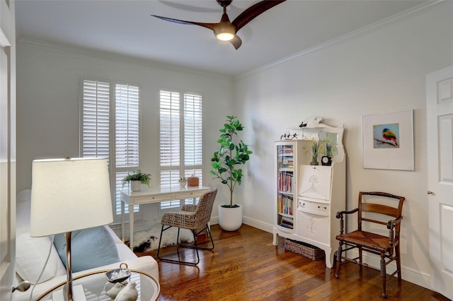 living area featuring dark hardwood / wood-style flooring, crown molding, and ceiling fan