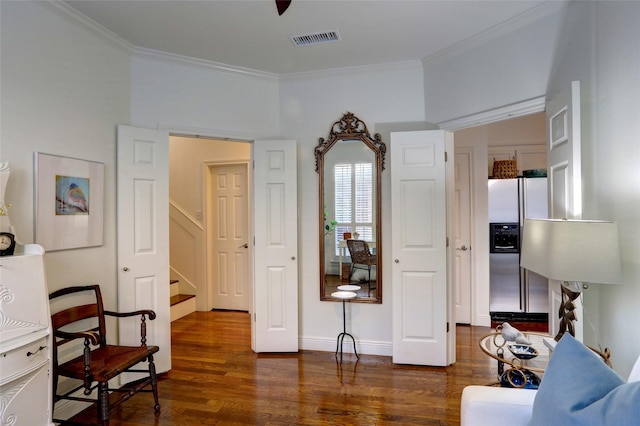 living area with dark hardwood / wood-style flooring and crown molding