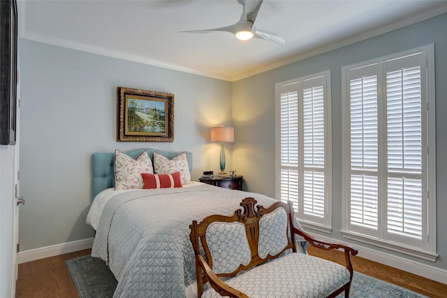 bedroom with hardwood / wood-style floors, crown molding, and ceiling fan