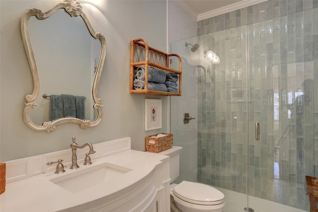 bathroom with an enclosed shower, vanity, crown molding, and toilet