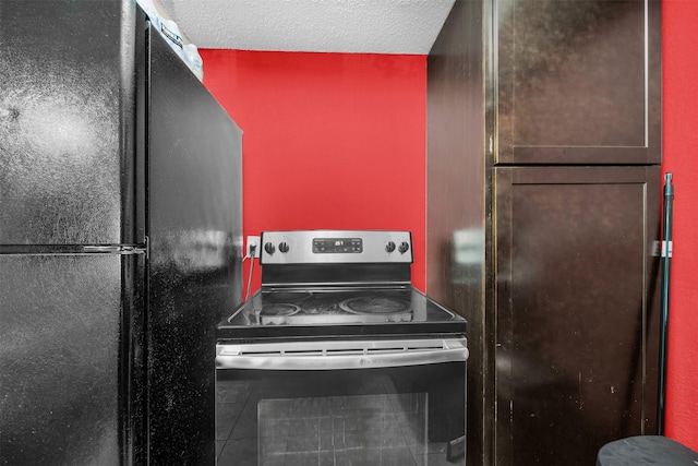 kitchen featuring black fridge and stainless steel electric range