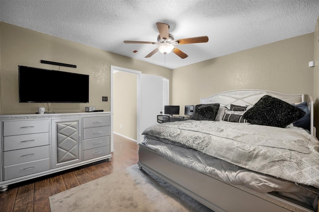 bedroom featuring ceiling fan, dark wood-type flooring, and a textured ceiling