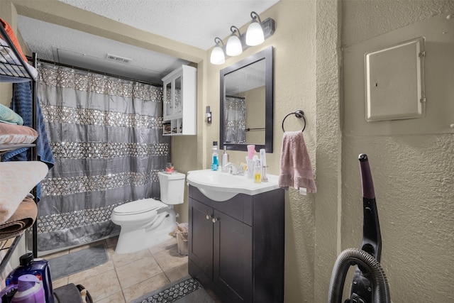 bathroom with tile patterned floors, toilet, a textured ceiling, vanity, and a shower with shower curtain