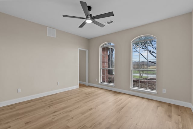 spare room featuring light hardwood / wood-style flooring and ceiling fan