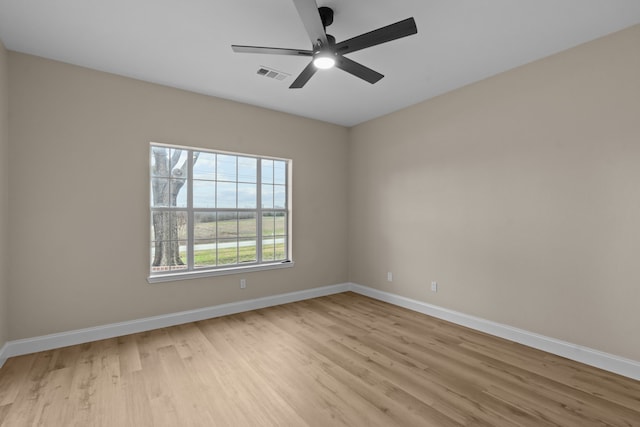 spare room with ceiling fan and light wood-type flooring