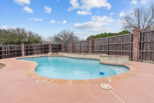 view of swimming pool with a patio and an in ground hot tub