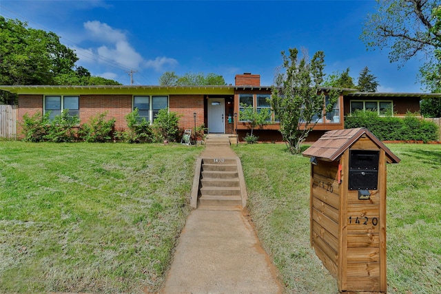 ranch-style home with a front lawn