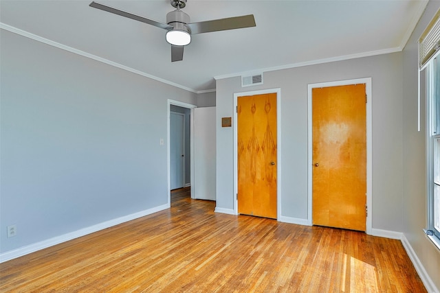 unfurnished bedroom with ornamental molding, ceiling fan, and light hardwood / wood-style flooring