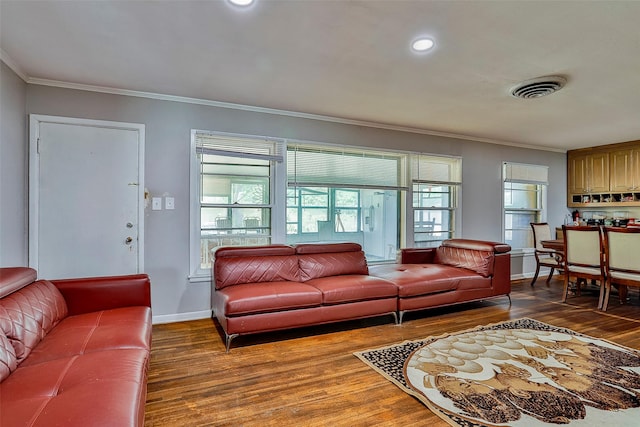 living room featuring hardwood / wood-style flooring and ornamental molding