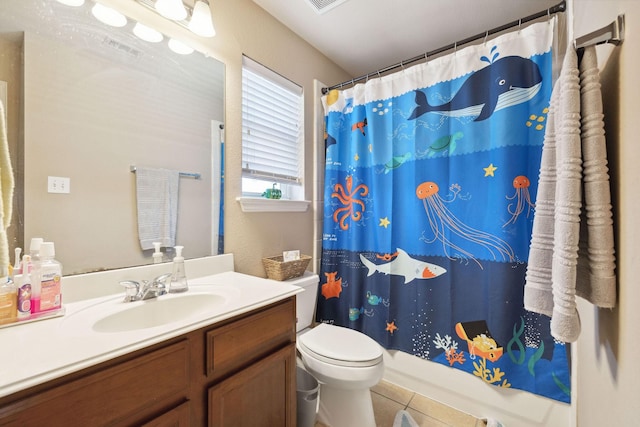 bathroom featuring vanity, toilet, and tile patterned flooring