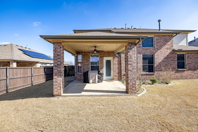 rear view of property with ceiling fan and a patio