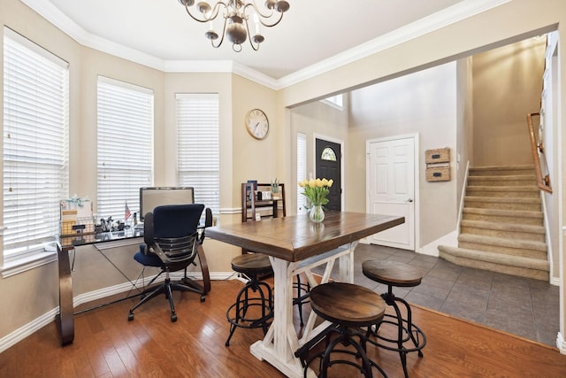 dining area featuring ornamental molding, a chandelier, and dark hardwood / wood-style flooring