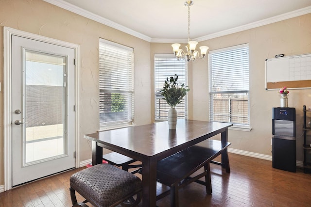 dining space featuring dark hardwood / wood-style flooring, a notable chandelier, and crown molding