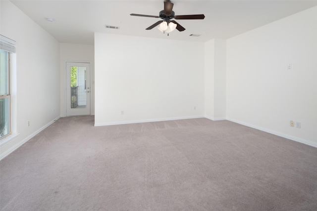 spare room featuring ceiling fan and light colored carpet