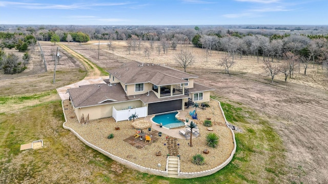 birds eye view of property with a rural view