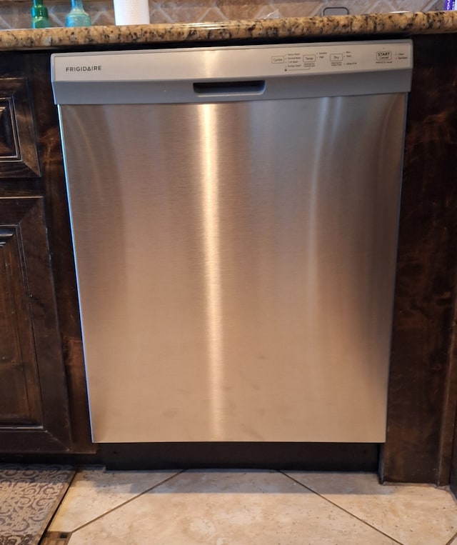 room details with dark brown cabinets and stainless steel dishwasher