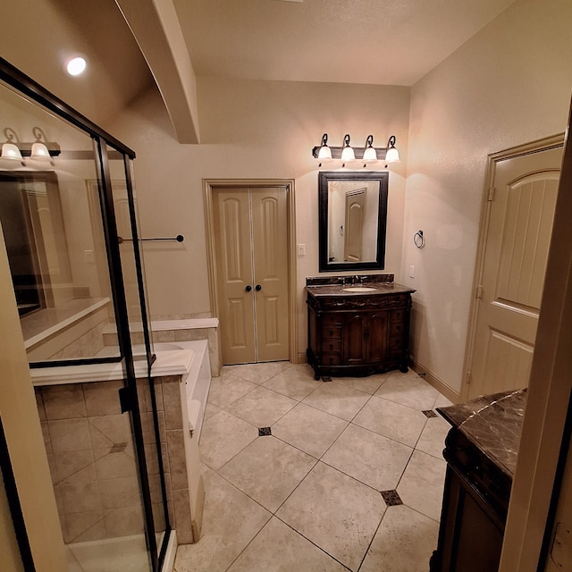 bathroom with tile patterned flooring, vanity, baseboards, a shower stall, and a bath