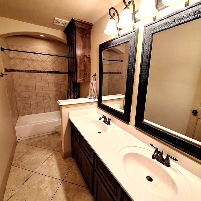 bathroom featuring toilet, tile patterned flooring, visible vents, and a sink