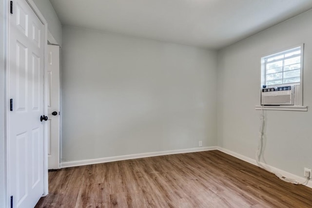 spare room with hardwood / wood-style flooring and cooling unit