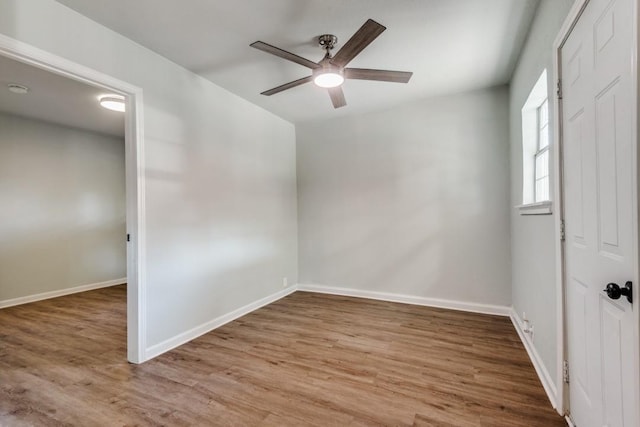 unfurnished room featuring hardwood / wood-style flooring and ceiling fan