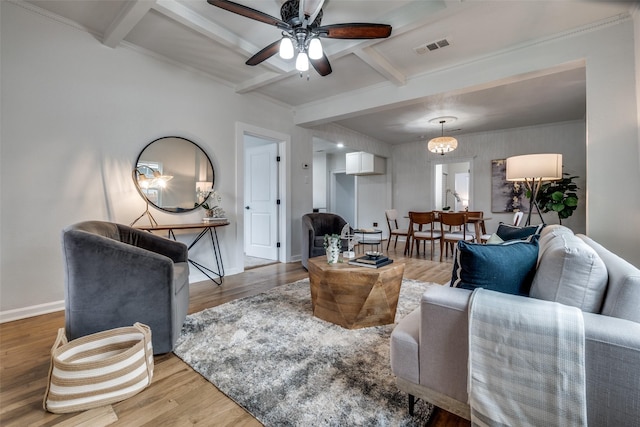 living room featuring ceiling fan, hardwood / wood-style floors, and beam ceiling