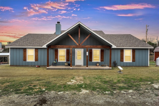 view of front of home featuring a patio area and a lawn