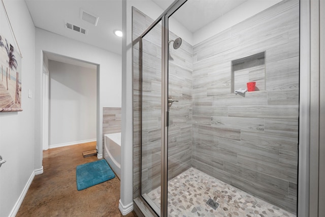 bathroom featuring shower with separate bathtub