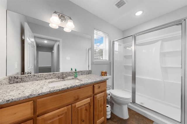 bathroom with vanity, toilet, and walk in shower