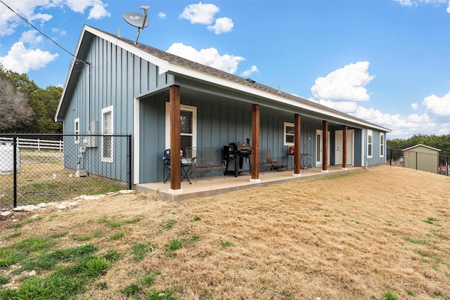 rear view of house featuring a yard