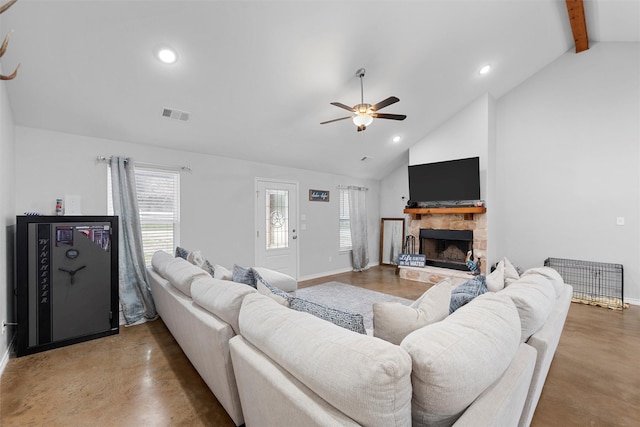 living room featuring a stone fireplace, high vaulted ceiling, beamed ceiling, concrete floors, and ceiling fan