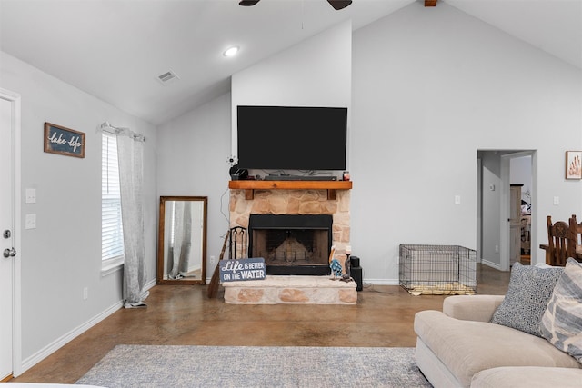 living room featuring ceiling fan, a fireplace, high vaulted ceiling, and concrete floors