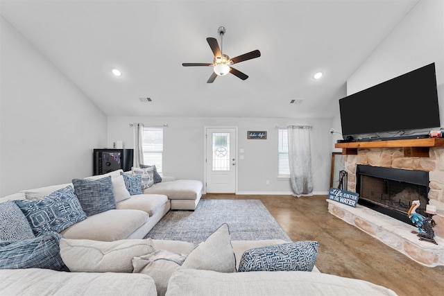 living room featuring a stone fireplace, plenty of natural light, high vaulted ceiling, and ceiling fan