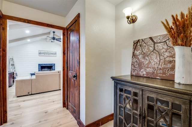 hallway with light hardwood / wood-style floors