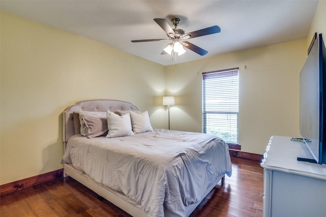 bedroom with dark hardwood / wood-style floors and ceiling fan