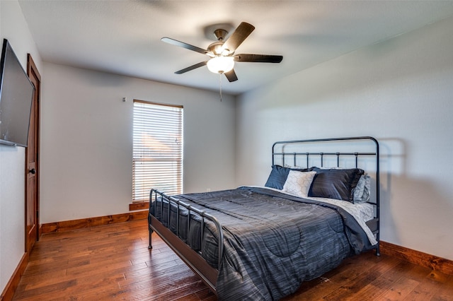 bedroom featuring ceiling fan and dark hardwood / wood-style flooring